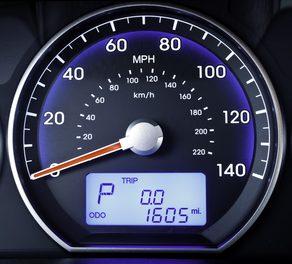 Speedometer in parked car, with LCD display of odometer and trip calculator.jpeg